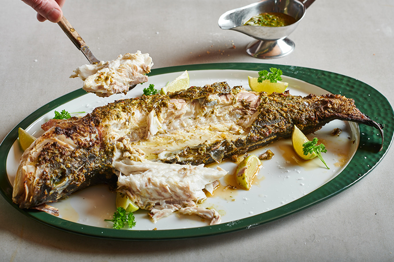 Whole sea bass from the Big Green Egg with herb salsa